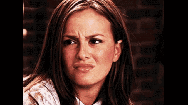 a close up of a woman making a funny face .
