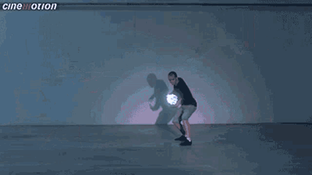 a man is dancing in front of a wall that says cinemotion on the bottom