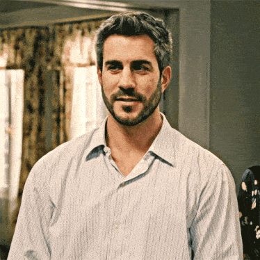 a man with a beard in a striped shirt