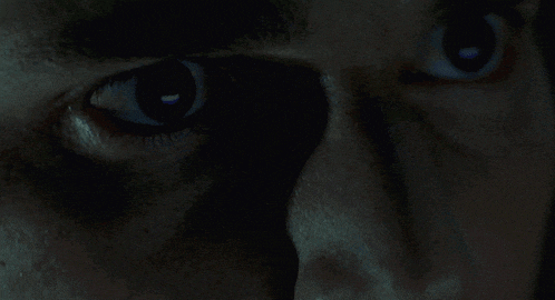 a close up of a man 's eye with a shadow on his face