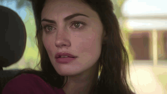 a close up of a woman 's face with a tear running down her cheek