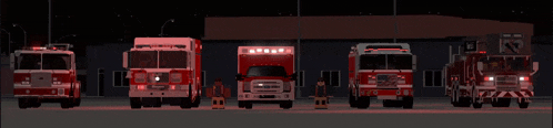 a row of fire trucks are parked in front of a building with a sign that says emergency