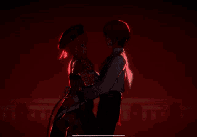 a boy and a girl are dancing together in front of a red background