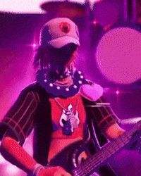 a man in a mask is playing a guitar in front of a drum set .