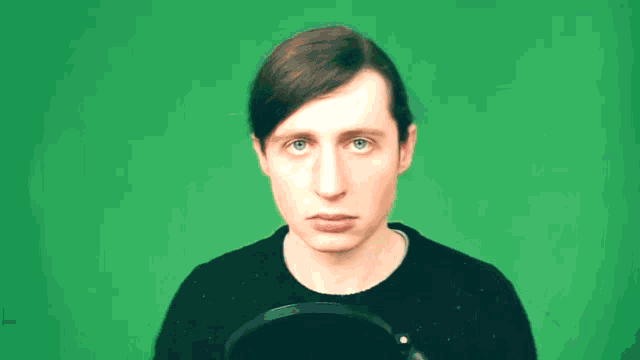 a man is making a funny face and pointing up with his finger