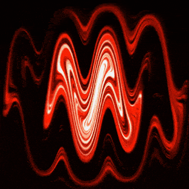 a red swirl in the middle of a dark room