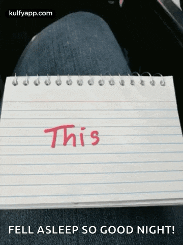 a notepad with the word this written on it is sitting on a person 's lap .