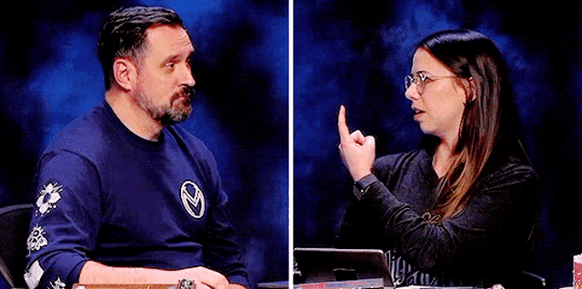 a man and a woman are sitting next to each other on a stage .