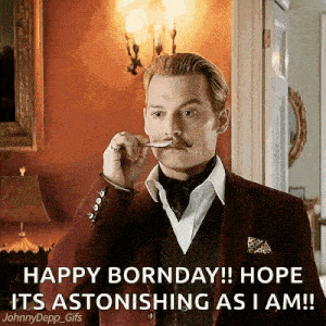 a man in a suit with a mustache is holding a spoon in his mouth