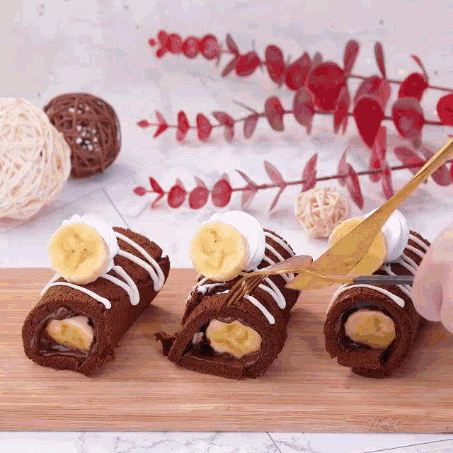 a person is cutting a chocolate roll with bananas and marshmallows