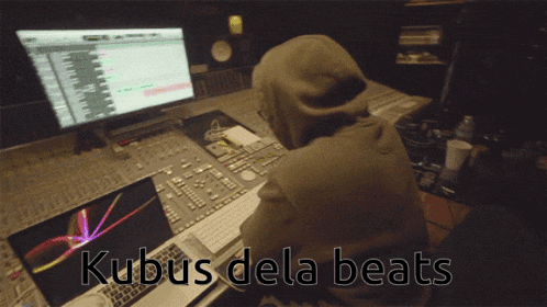 a man in a hoodie sits in front of a computer with the words kubus dela beats written above him