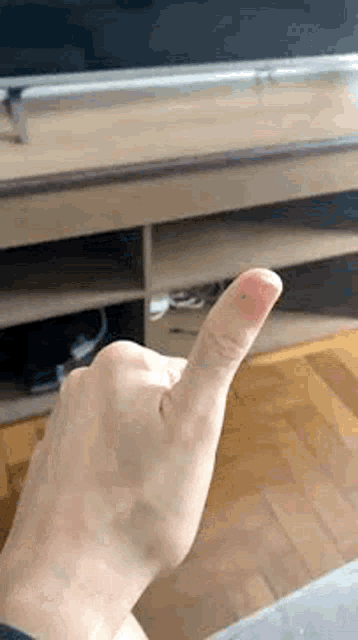 a close up of a person 's finger with blood on it in front of a television .