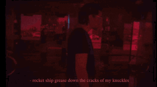 a rocket ship grease down the cracks of my knuckles is written on a red background