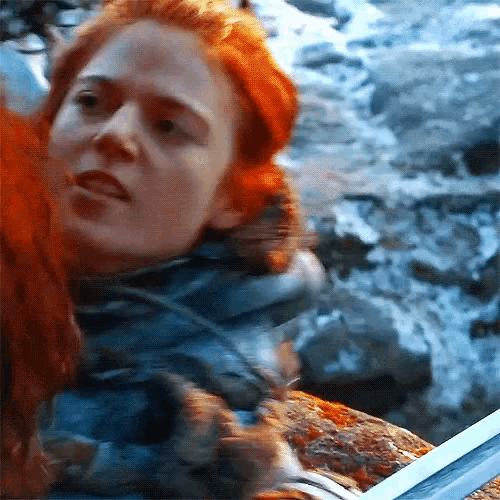a close up of a woman 's face with red hair