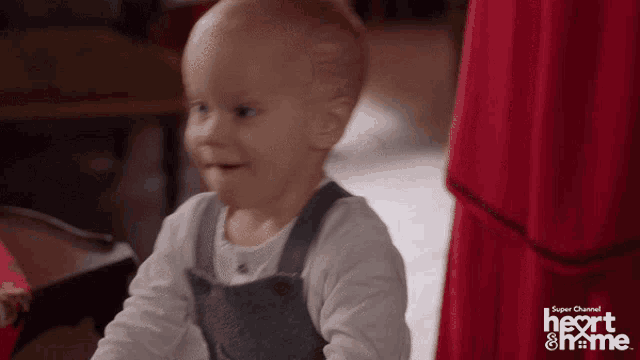 a baby is sitting in front of a sign that says heart and me