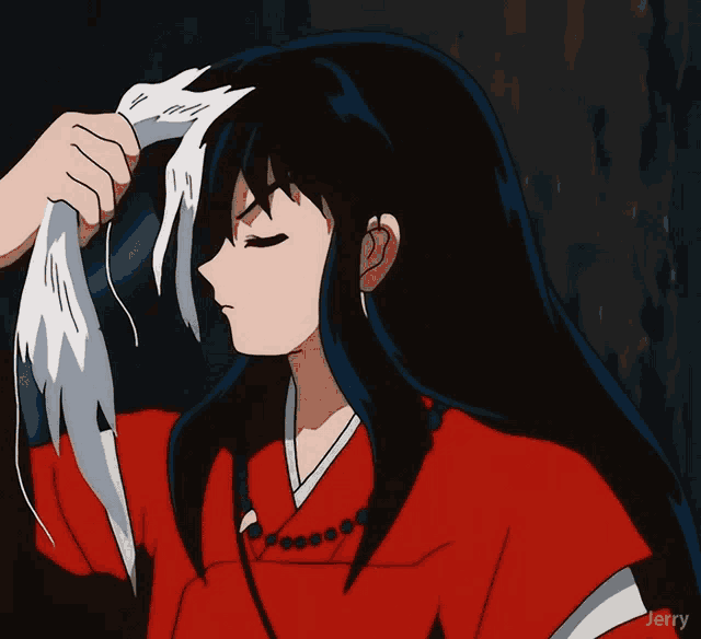 a girl in a red shirt is holding a white cloth in her hand
