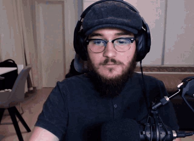a man with glasses and a beard wearing headphones