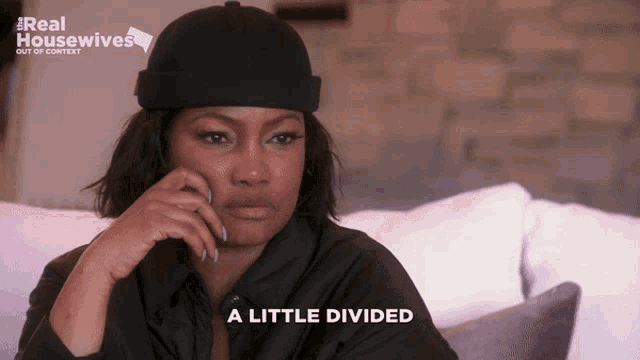 a woman sitting on a couch with the words a little divided on the bottom