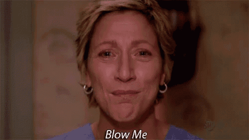 a woman is crying and saying blow me in a close up of her face .