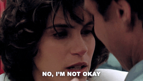 a woman says no i 'm not okay while a man looks on