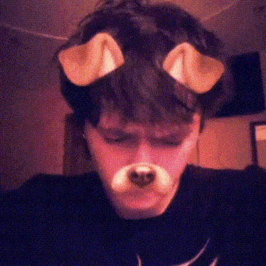 a young man wearing a fake dog nose