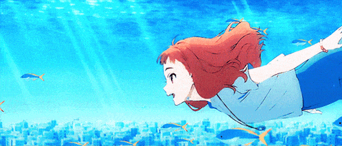 a girl with red hair is swimming in the ocean surrounded by fish .