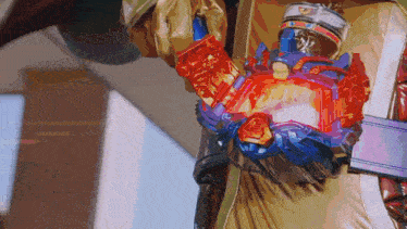 a close up of a person holding a red and blue item