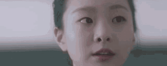 a close up of a woman 's face with her eyes closed and her mouth open .