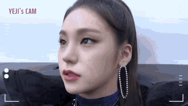 a close up of a woman 's face with the words yeji 's cam on the bottom right