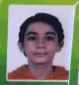 a close up of a young boy 's face in a green frame on a green background .