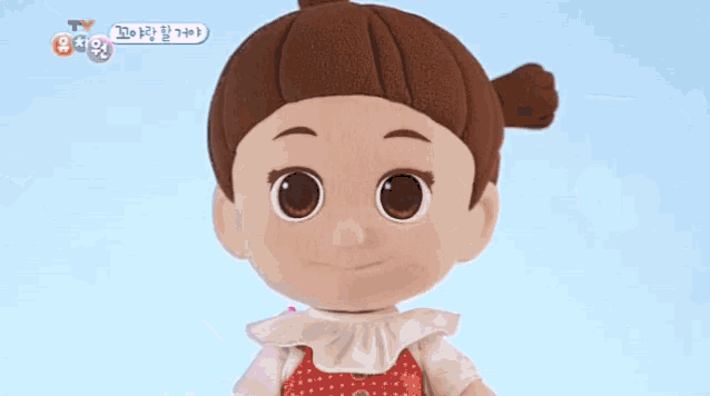 a close up of a stuffed doll with hearts surrounding her