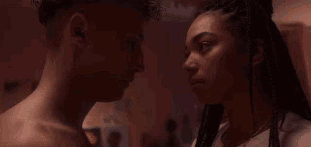 a man and a woman are looking at each other with their eyes closed