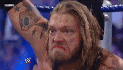 a man with a tattoo on his arm is making a funny face .
