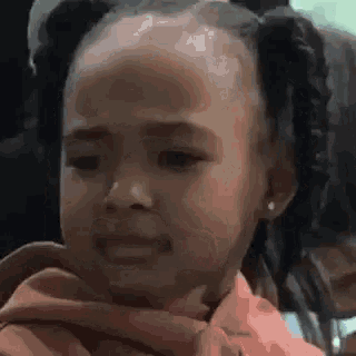 a little girl is crying while sitting in a car .