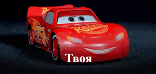 a toy lightning mcqueen from the movie cars is driving down a road .