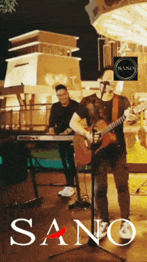 a man playing a guitar and singing into a microphone with the word sano on the bottom right