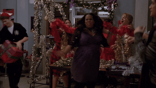 a woman in a red feather boa is cheering