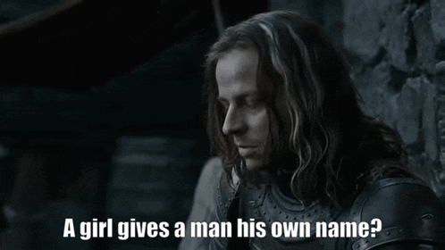 a man with long hair is asking a girl if she gives a man his own name