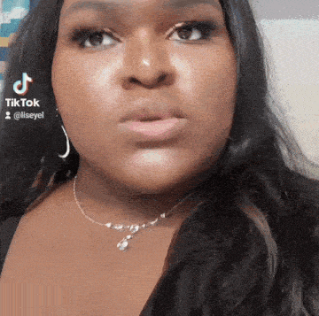 a close up of a woman 's face with tiktok written on the bottom right