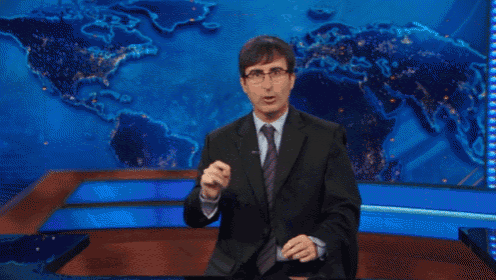 a man in a suit and tie is dancing in front of a large map of the world