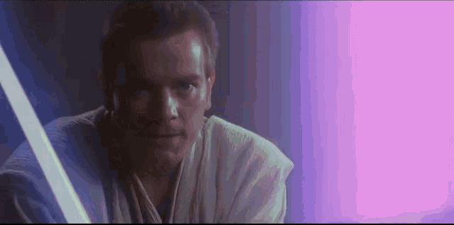 a close up of a man holding a light saber