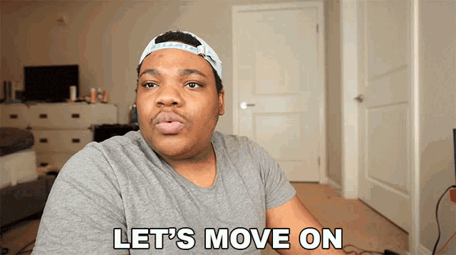 a man says let 's move on while wearing a hat