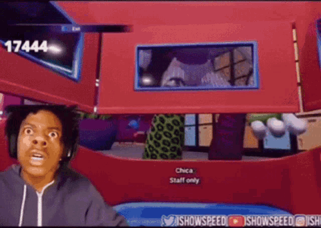 a man is playing a video game with the number 17444 in the background