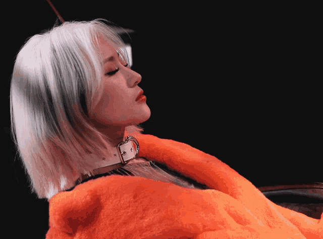 a woman with white hair is wearing a fur coat