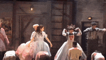 a group of people are dancing in front of a sign that says " building "