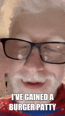 a man with glasses and a beard says he gained a burger patty