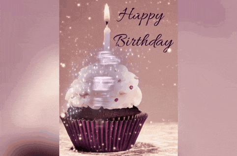 a birthday card with a cupcake with a lit candle