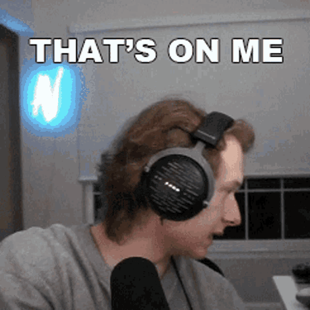 a man wearing headphones and a microphone with the words that 's on me above him