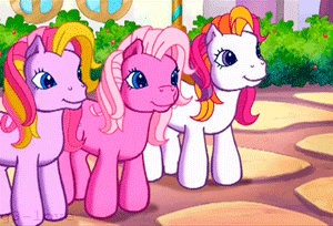 three pink ponies are standing next to each other on a sidewalk