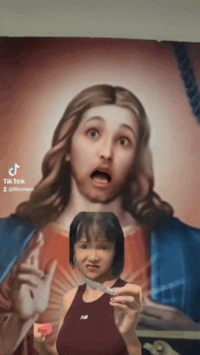 a girl is holding a knife in front of a jesus painting